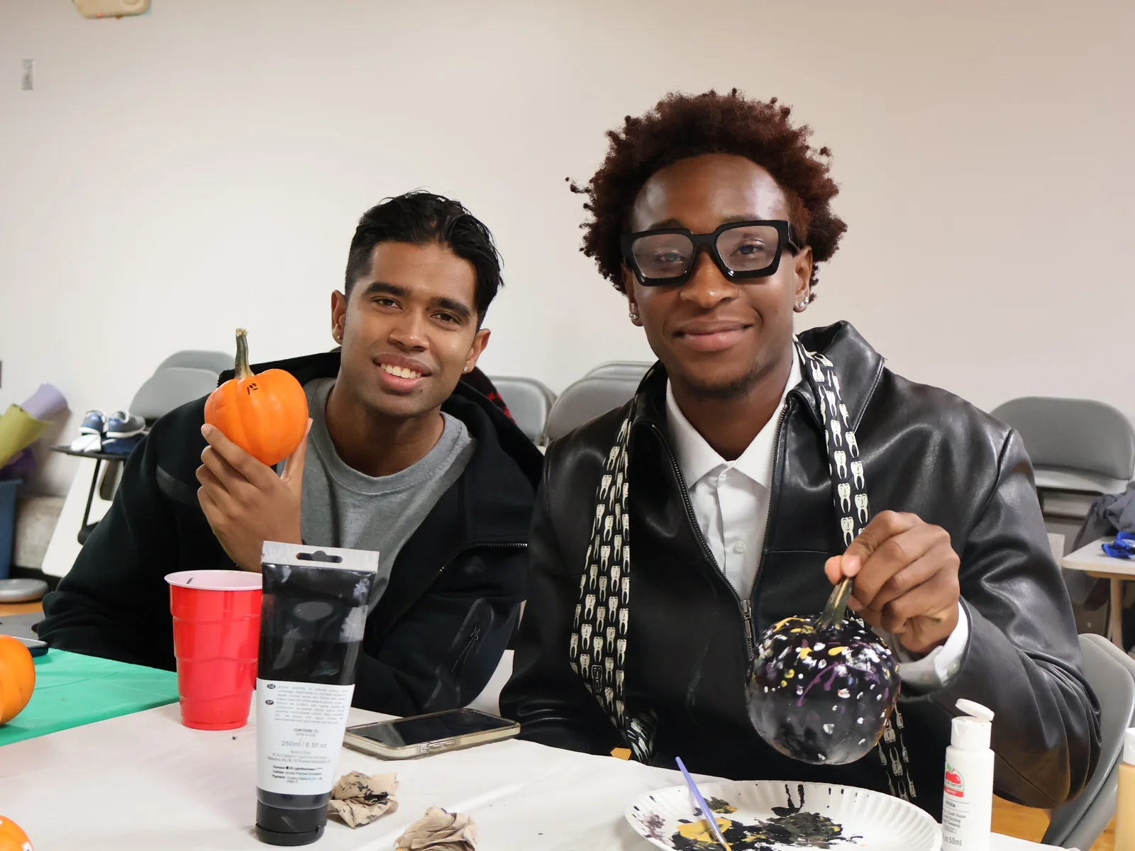 Three students sit at a table in the cafe for a Movie and Meal event