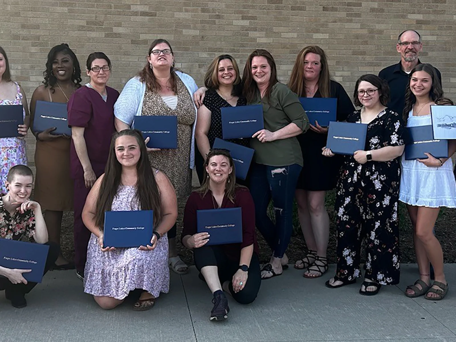 Group of 14 students posing with two FLCC staff members