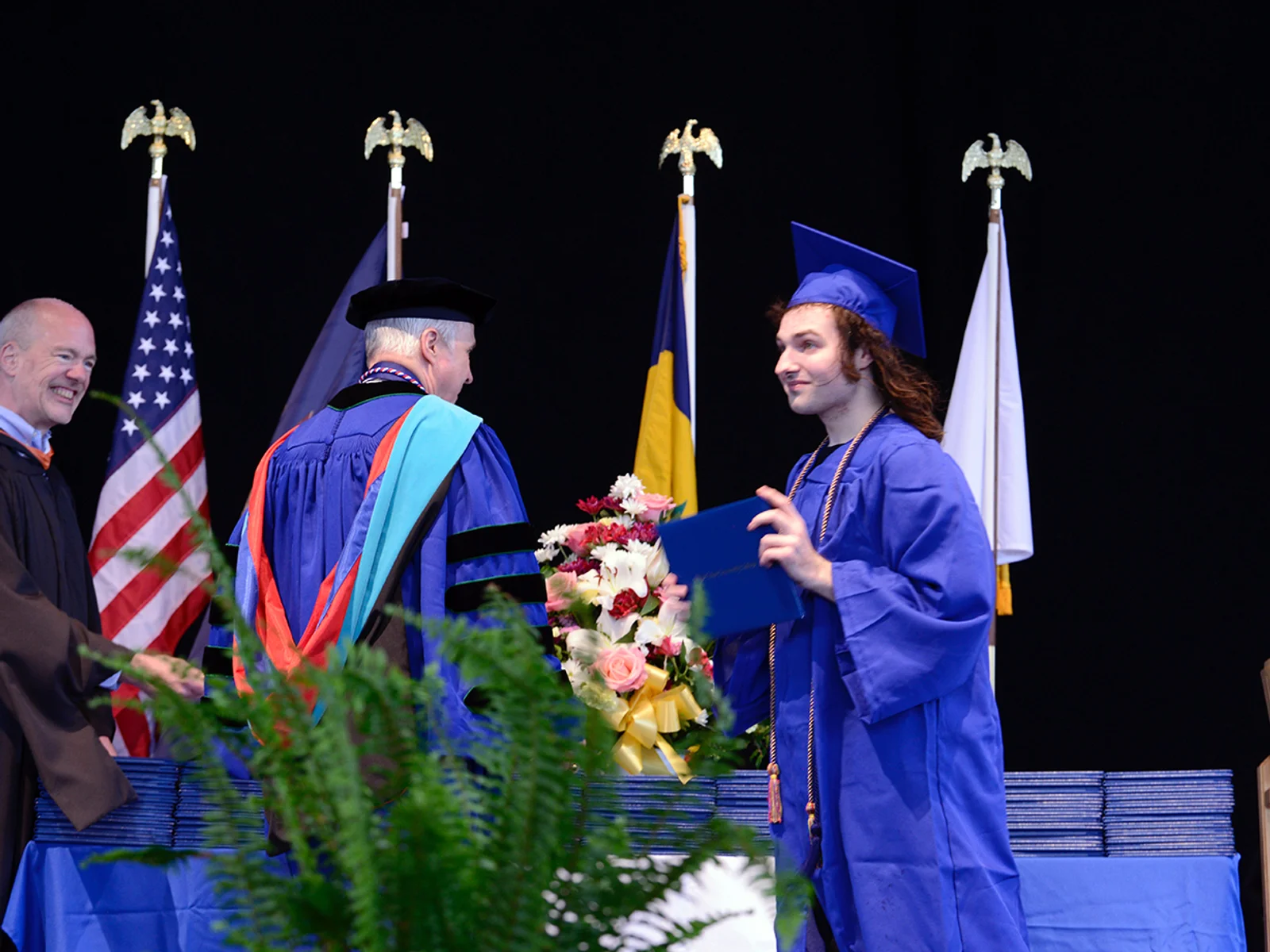 Young man getting diploma at ceremony