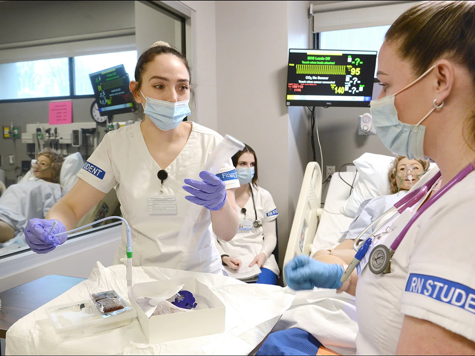 Two nursing students in uniforms in a hospital environment
