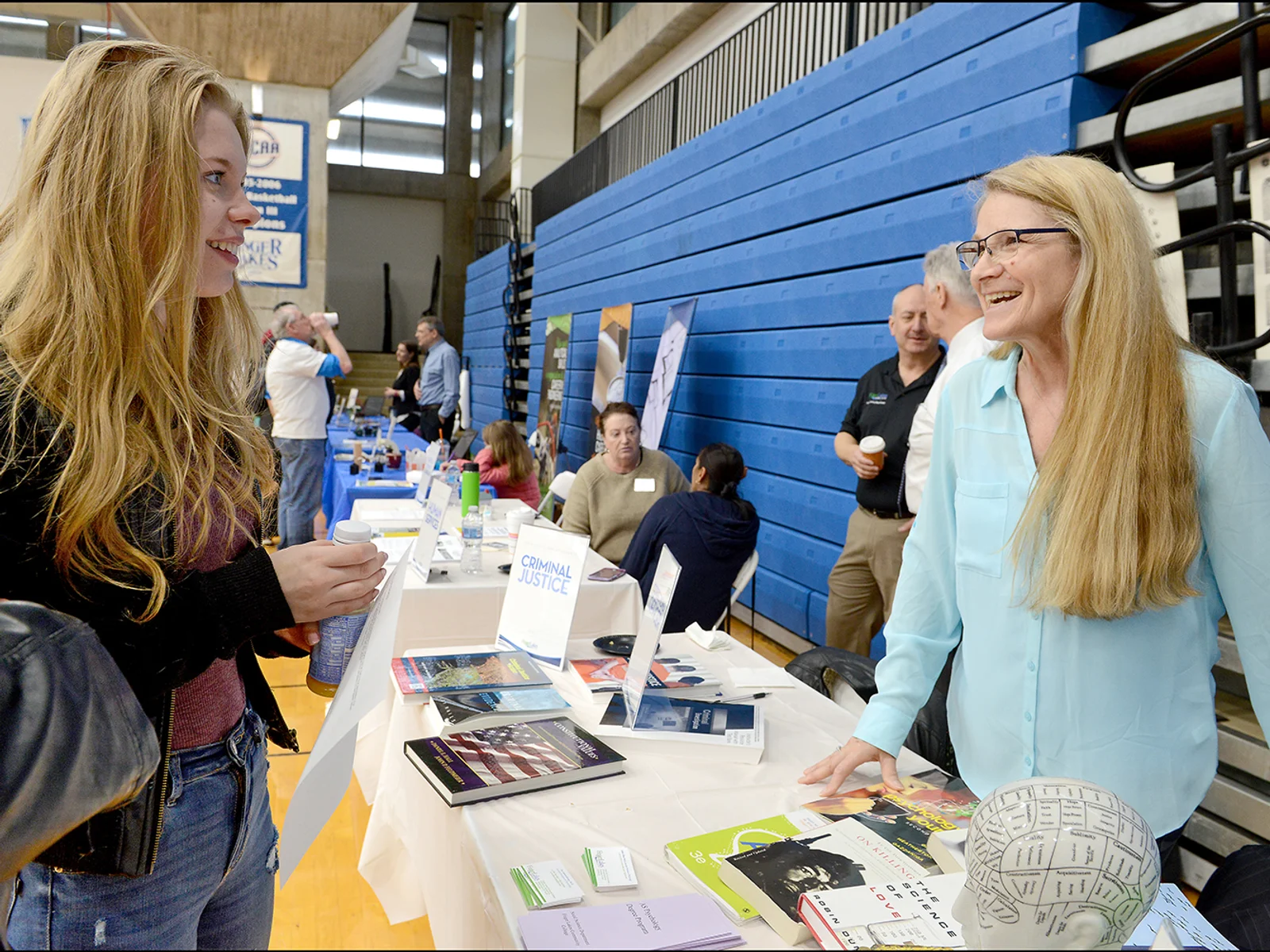 Young woman talking to female professor