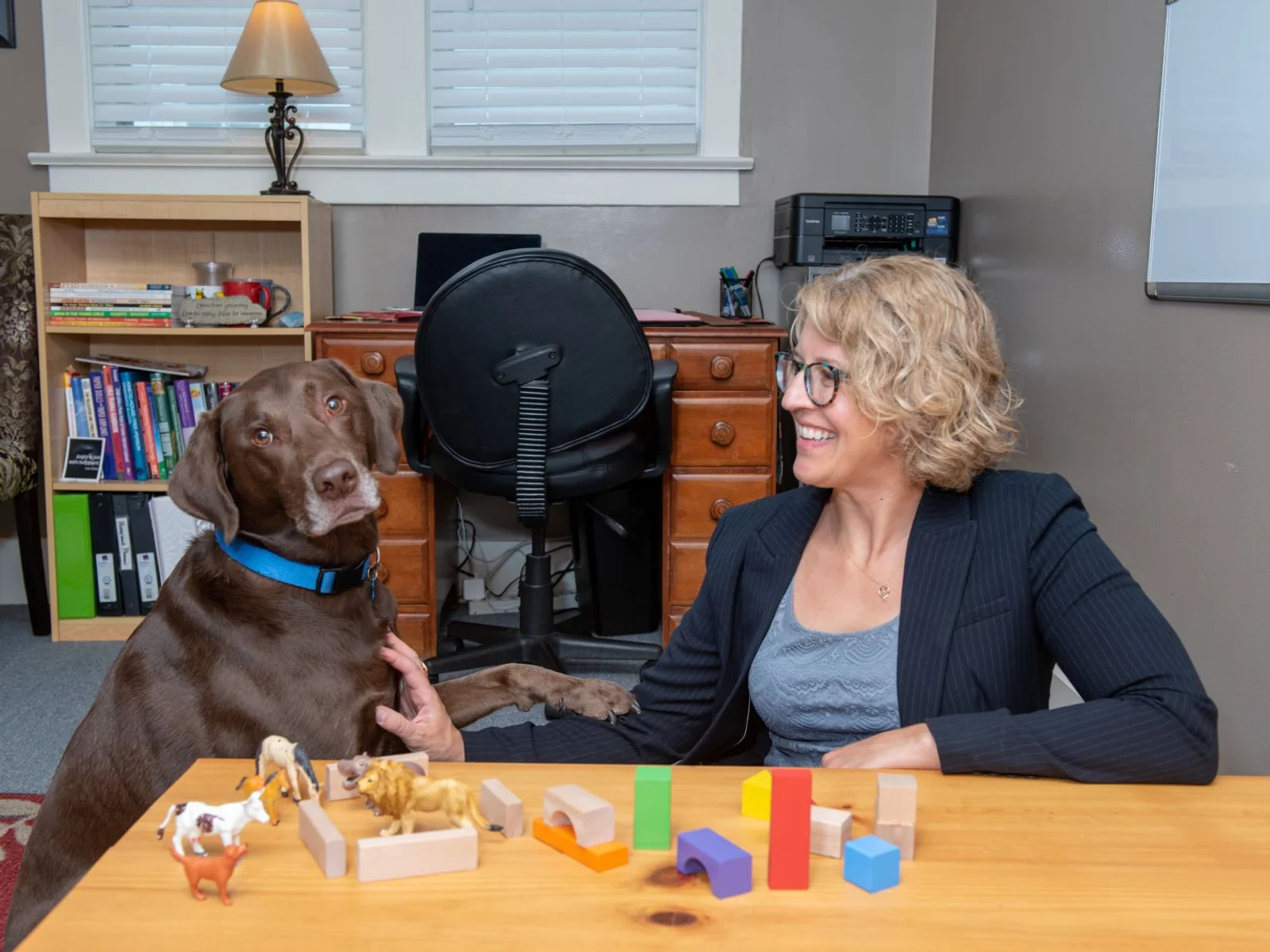 Woman smiling at her large brown dog