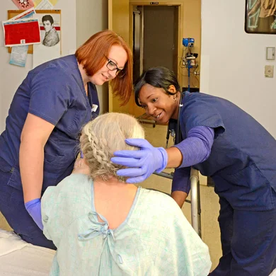 Healthcare professional students working with a patient