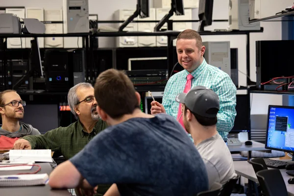 Professor in networking class with students