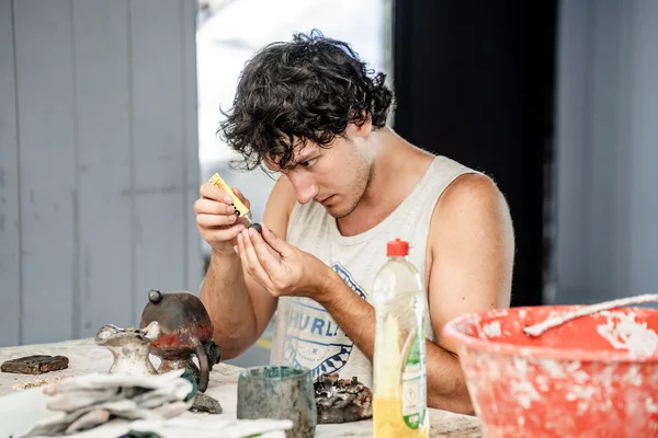 Study abroad student works on pottery