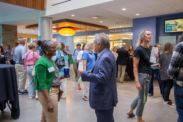 FLCC colleagues greet one another in the Atrium at the start of the semester.