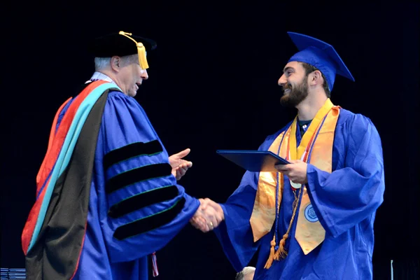 Daniel DiSalvo receives diploma from college president