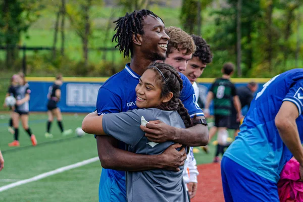 Two FLCC soccer players hugging after a game