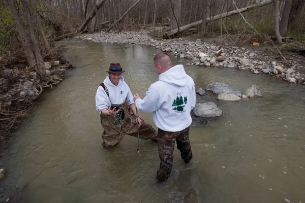 Students wading in stream