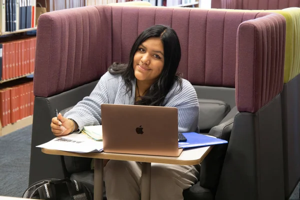 FLCC student studies at a single person station in the Library.
