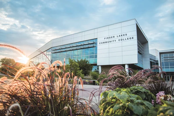 FLCC main campus, with the sun rising in the background.