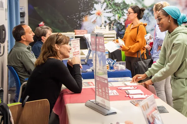 Students meeting with representatives from regional four-year colleges during a transfer event.