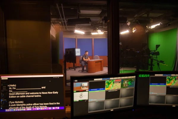 Communications students working with digital video production software.