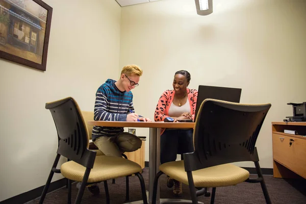 An FLCC student and admissions counselor completing college paperwork together.