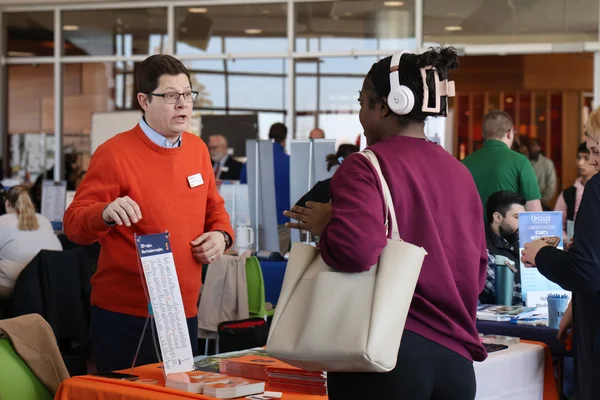 Representative from Syracuse University discussing transfer options with an FLCC student.