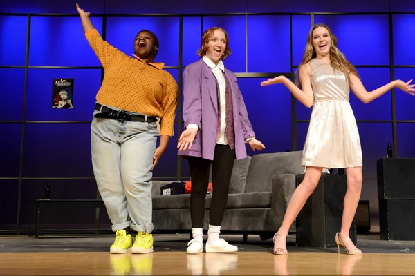 FLCC students on stage in the middle of a live theatrical performance.