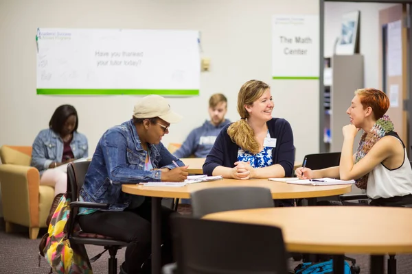 Staff member and students in the Academic Success and Access Programs center.