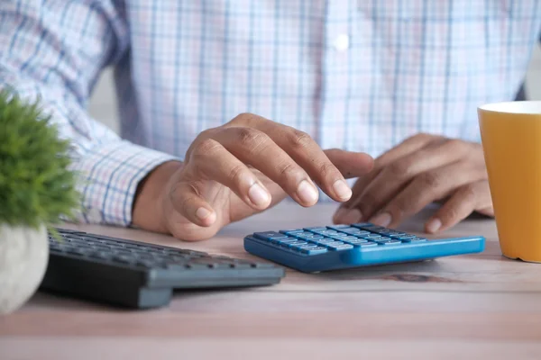 A person calculating the cost of an upcoming payment.