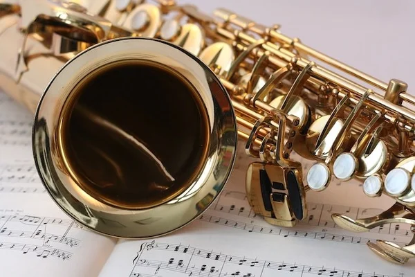 Close up photo of a brass instrument on top of sheet music