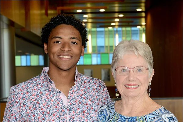 A young man posing with an older woman