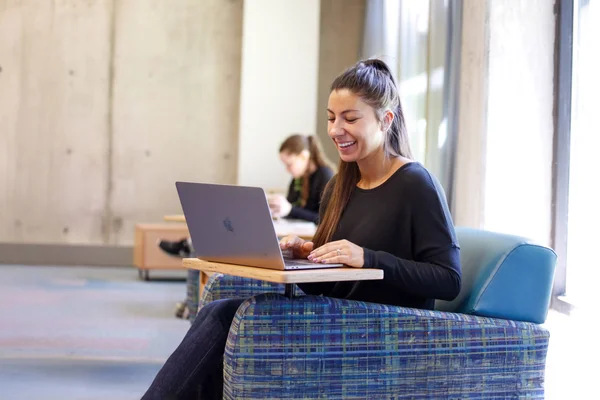 A student using a laptop computer to participate in an online class