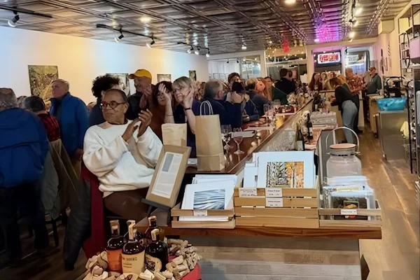 A large group of people gather in a restaurant for an event.