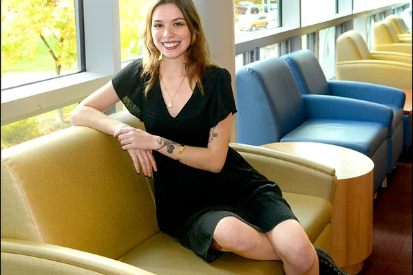 Lauren Smith seating on a chair in the student lounge