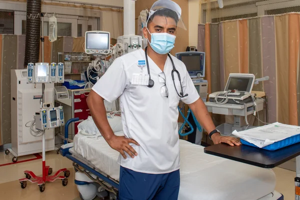 Nursing student in uniform prepped for working with patient.