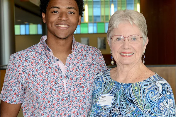 A young man posing with an older woman