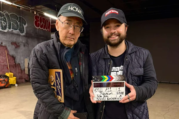 John W. Kim standing next to Noah Pitifer on the set of 'Reunion'
