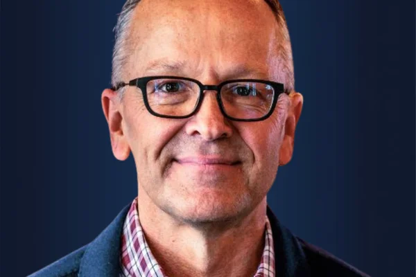 Headshot of a man wearing glasses