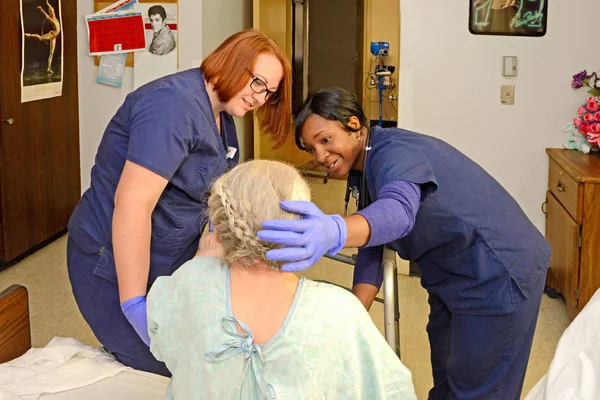 Healthcare professional students working with a patient