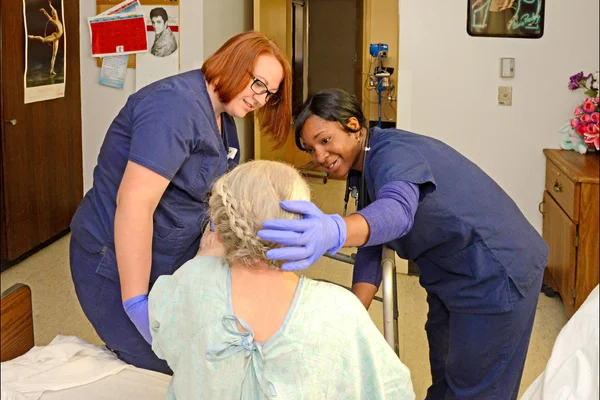 Healthcare professional students working with a patient