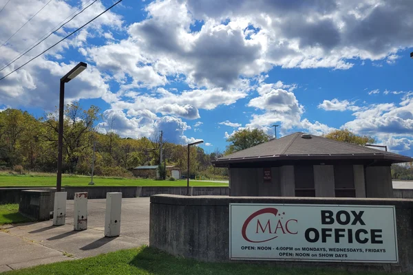 Landscape view of the Constellation Brands Marvin Sands Performing Arts Center (CMAC) box office on a cloudy, blue-sky day.