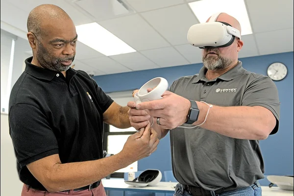 Instructor with student using virtual reality headset 