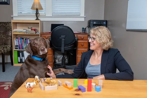 Woman smiling at her large brown dog