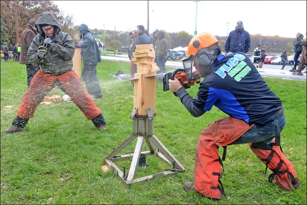 logging sports team member chainsawing log