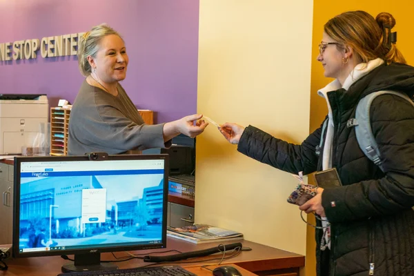 One Stop Center staff member assists a student.