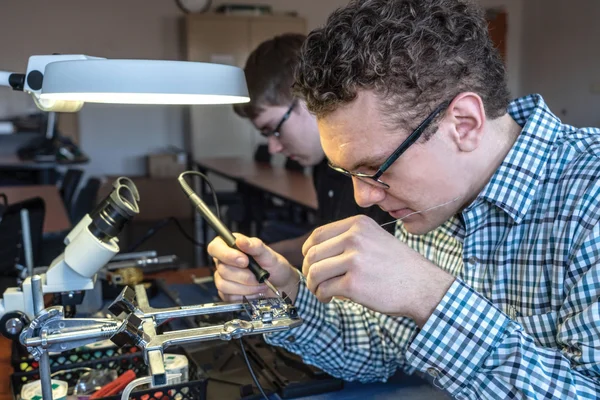 Smart Systems Technologies student building an electronic device at FLCC.
