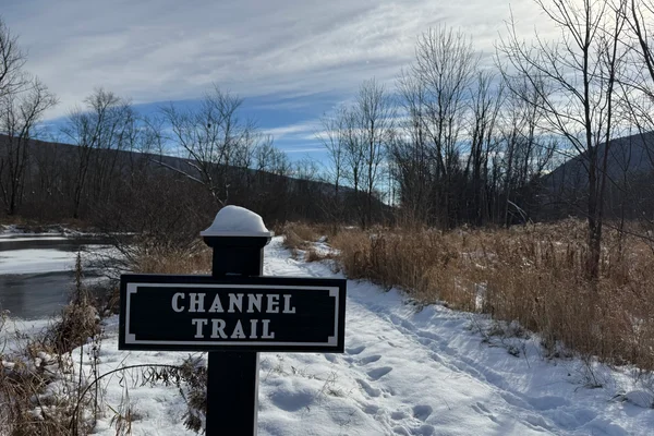 Channel Trail sign in front of snowy trail