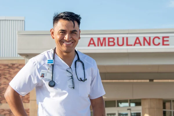 Nurse standing outside hospital emergency entrance
