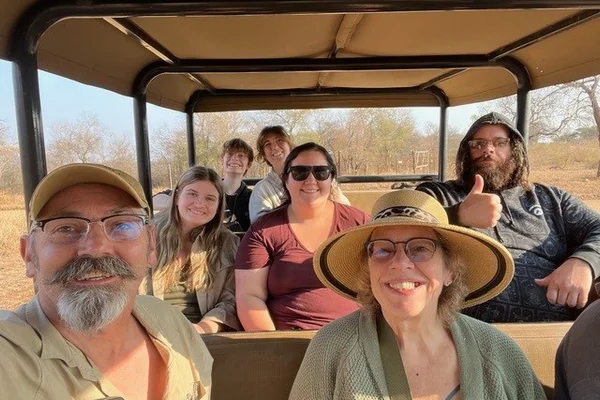A view of passengers in an open air truck on a game reserve