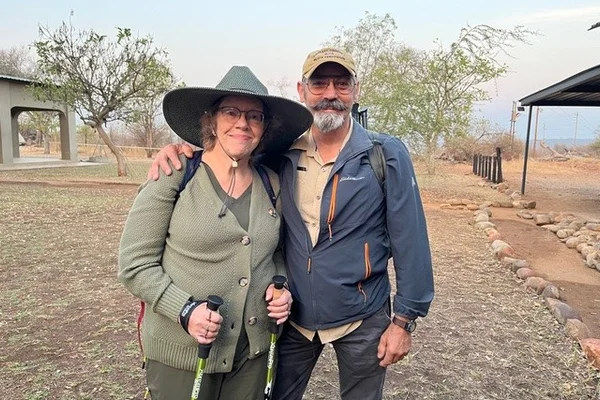 Older man and woman posing outdoors in South African reserve