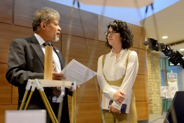 Man speaking to woman at trade show
