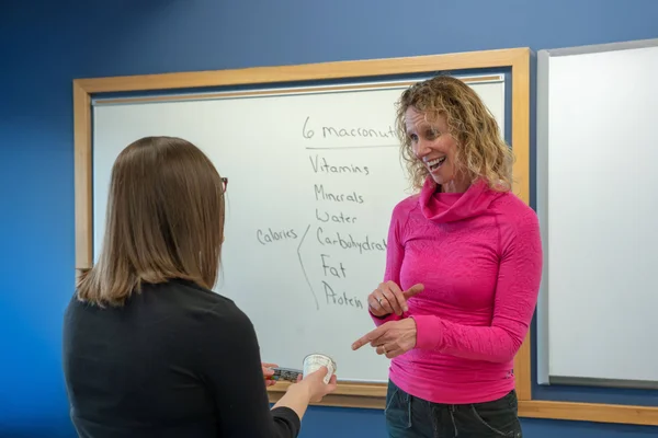 A nutrition and dietetics student talking to faculty after class.