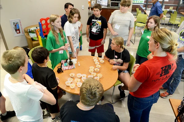 Instructor and students gathered around a table