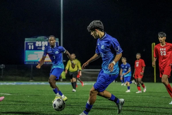 Two players from the FLCC men's soccer team on the field
