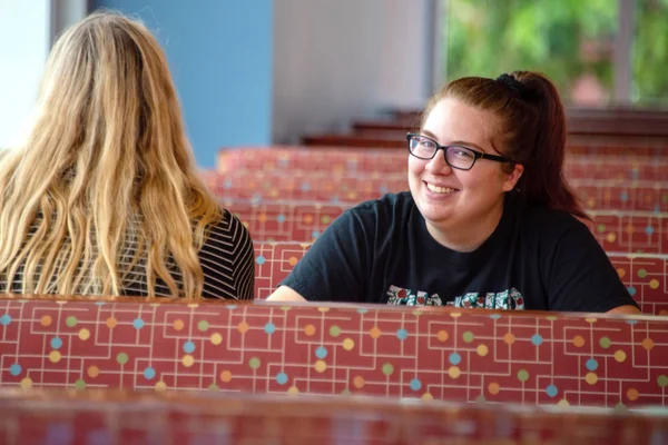 Two students relaxing in the on-campus cafe.
