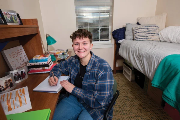 An FLCC student studying in a private bedroom at The Suites at Laker Landing.