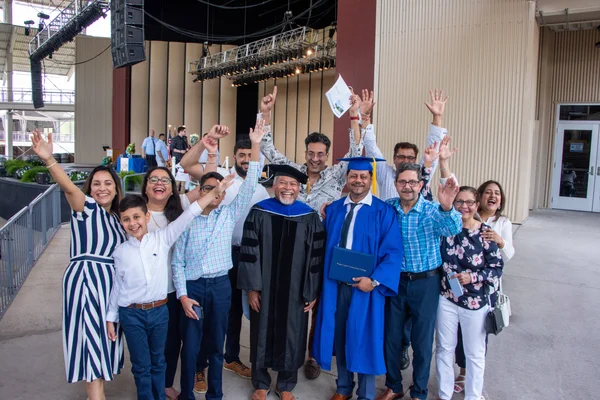 A group of FLCC graduates, faculty, and community members celebrating at commencement.